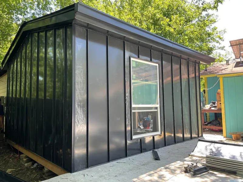 Black standing seam metal wall panels for Metal Roof Installation in August