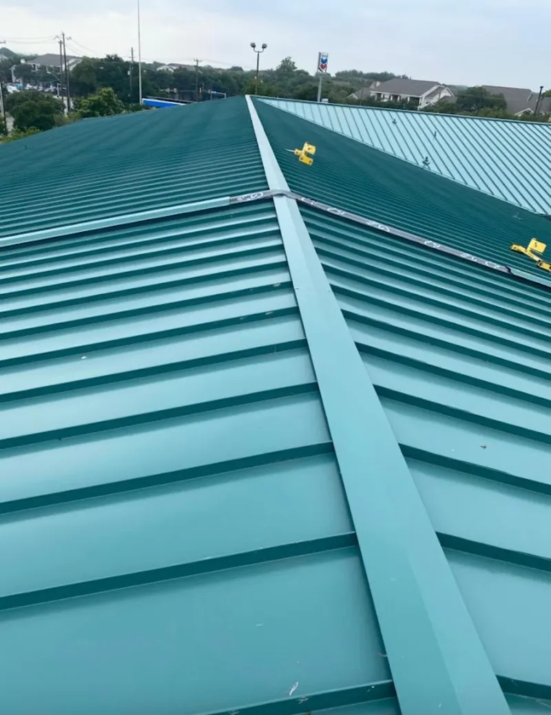 Green commercial metal roof ridge and valley for Metal Roof Repair in August